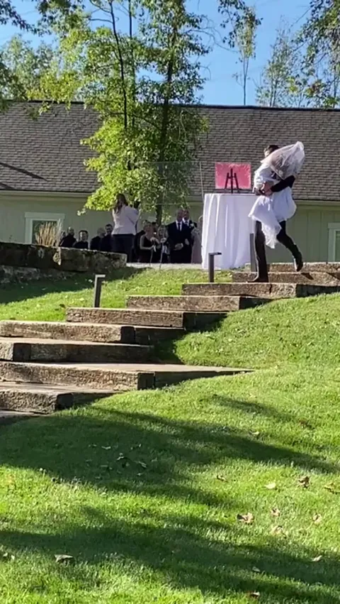 groom carries bride's special needs sister down the aisle so the sis could have her special moment too