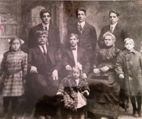 My GF is standing behind my GGF - circa 1910