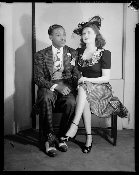 Sharp dressed couple, posing for their portrait in 1942. Safety Afga film.