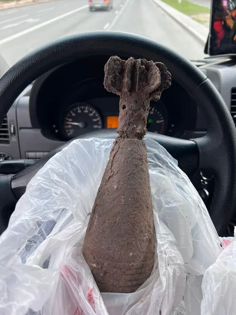 Deadly texting &amp; driving level 100. Dude takes a picture of an unexploded mortar shell from ww2 - while driving, holding both, phone and UXO. 