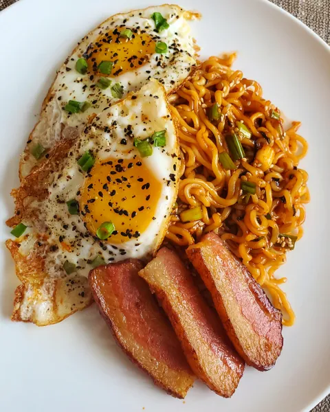 Spicy instant noodles with crispy fried eggs and thick cut bacon