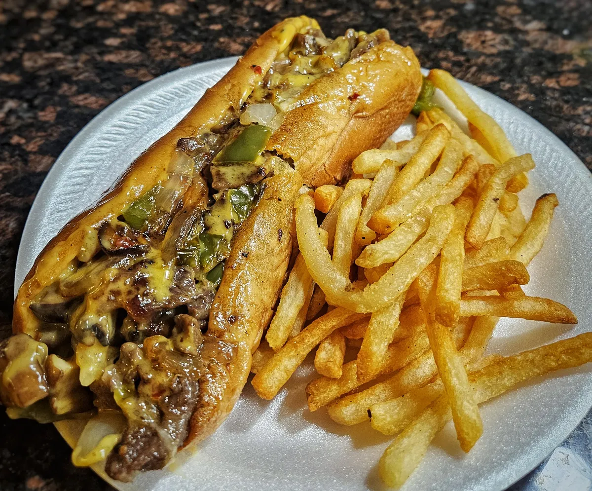 Cheesesteak. Ribeye, provolone, whiz, peppers, onions, and mushrooms.