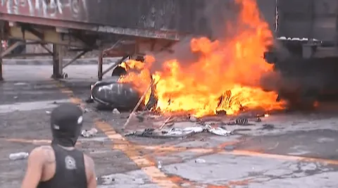 Protesters set fire to a container van at Ayala Bridge